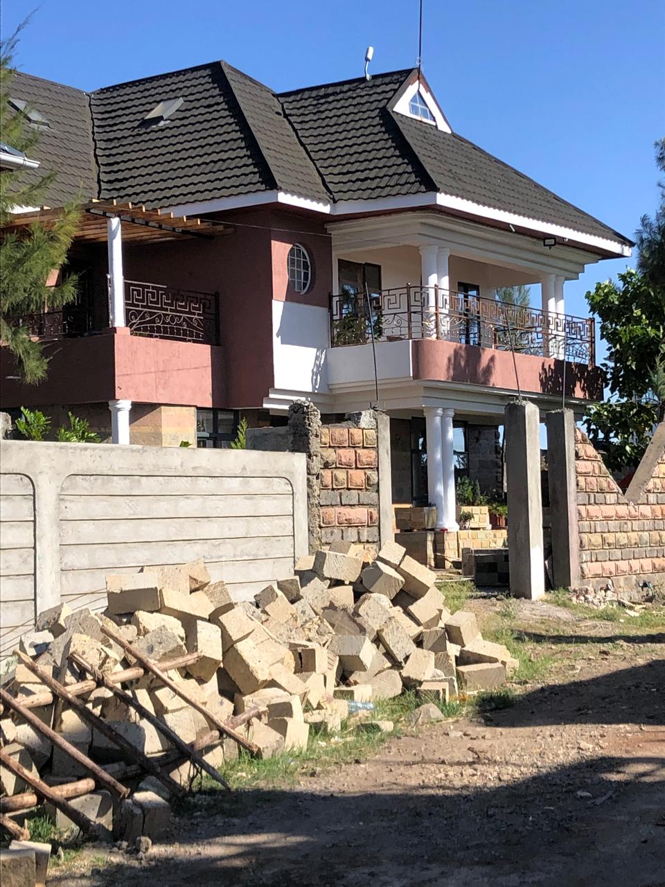 Wide view of an Odi Craft Builders residence under construction — walling stage, Ruiru